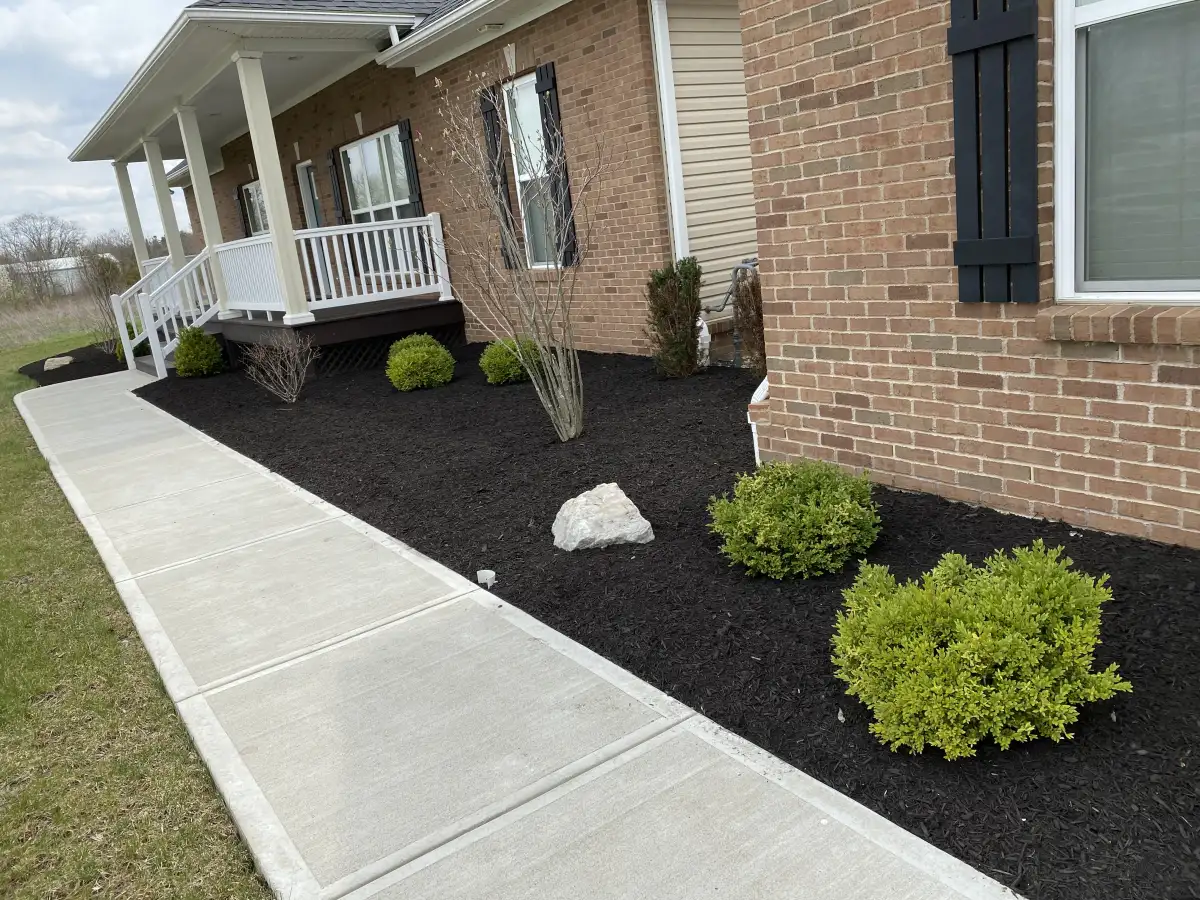 Landscape maintenance and mulching at a Plain City property