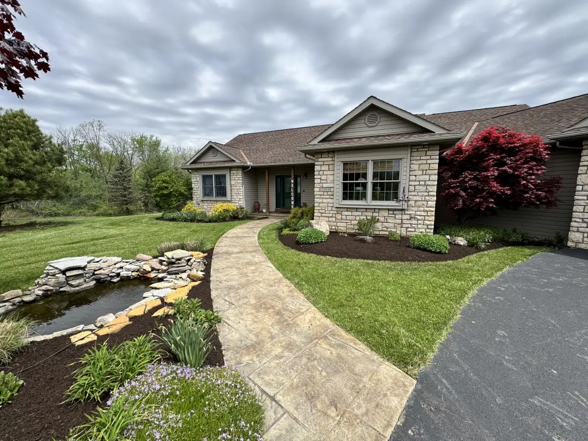 Professional landscape installation project in Marysville, Ohio featuring fresh plantings and mulch beds