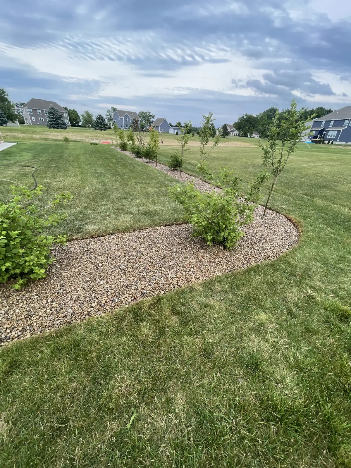 Professional landscape maintenance with fresh mulch and pruned shrubs at a Marysville, Ohio property